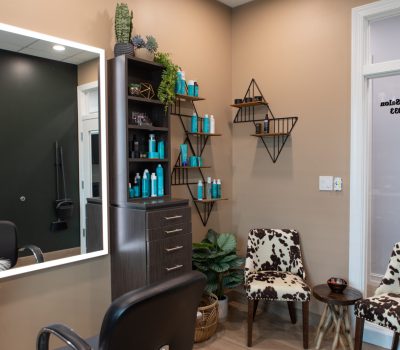 Hair & beauty supplies on shelves in waiting area of a salon suite.